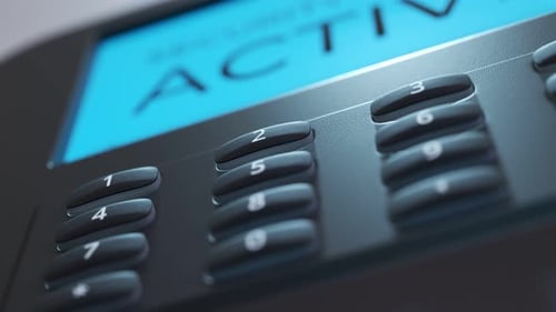 Security panel keypad on the wall. Screen showing the alarm being activated.4KHD