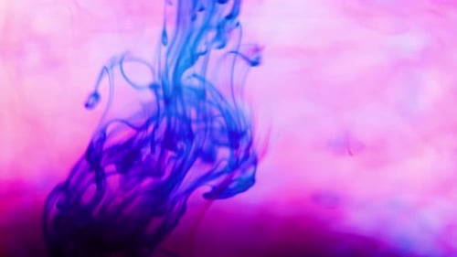 Abstract Fluid Ink Blending on Pink Background