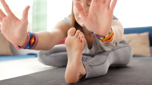 Young Woman Practicing Yoga in Yoga Room on City Background