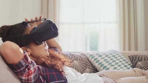 Woman Enjoying Virtual Reality Headset on Sofa