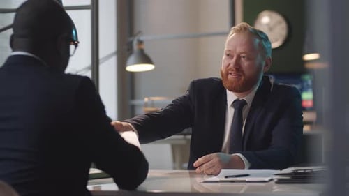 Businessmen Meeting in Office Discussing Documents