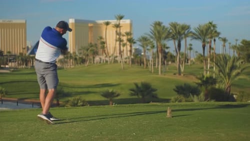 Man Driving Golf Ball on Sunny Golf Course