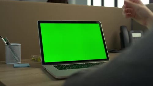 Businessman Typing on Laptop with Green Screen