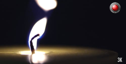 Close Up of Burning Candle in Dark Room