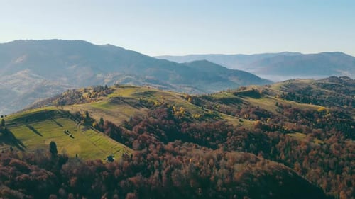 Panoramablick auf die malerische Landschaft mit grünen Waldhügeln und Berggipfeln an sonnigen Tagen