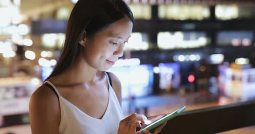 Woman use of mobile phone at night
