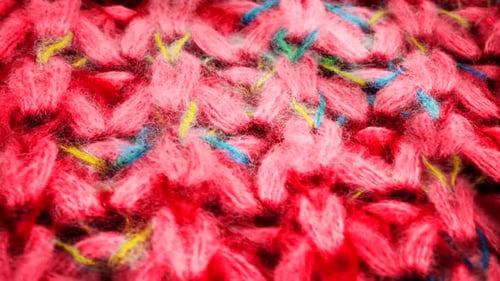 Warm Knit Fabric Macro with Colorful Specks Motion Background