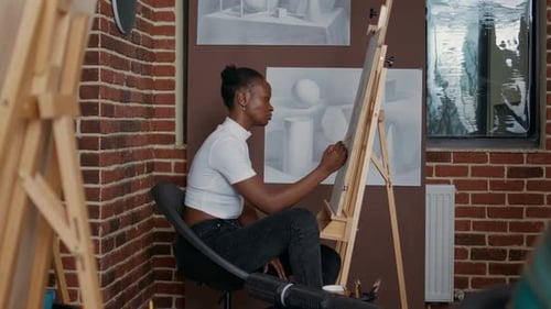 Young Adult Sketching Art on Canvas in Studio