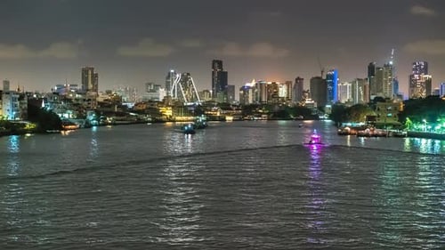 Time lapse night city and boats moving down on the river