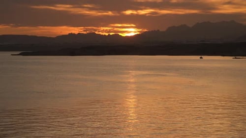 Sunset Reflection In the Sea One Can See the Outlines Of the Mountains