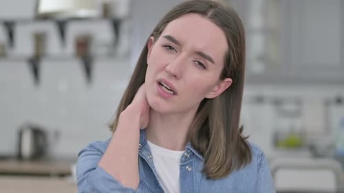 Young Woman Massaging Stiff Neck, Close Up