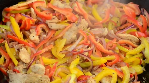 Cooking Peppers, Onions, and Chicken in a Pan