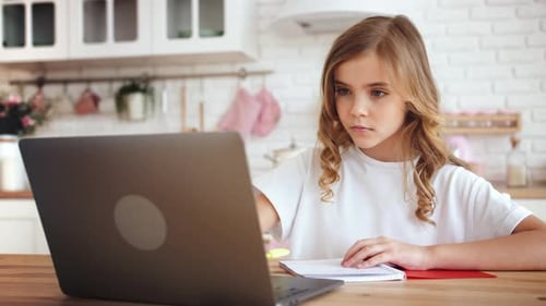 Girl Studying Online at Kitchen Table