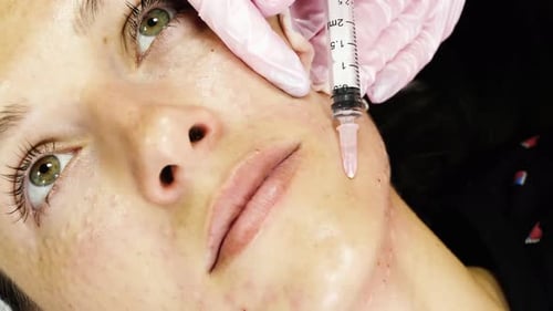 Woman Receiving Cosmetic Injection in Cheek