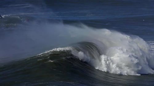 Surfistas y motos acuáticas en grandes olas