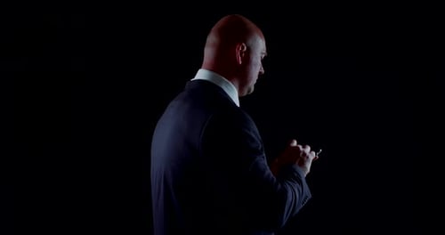 Chefe sério está ligando pelo celular, figura giratória na escuridão