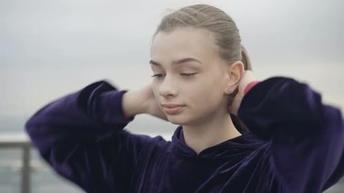Young Woman Stretching Her Neck Outdoors