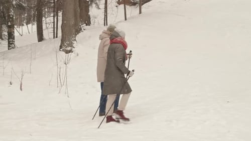 Senior Couple Hiking in Winter Snow Forest