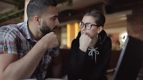 Man and Woman Collaborating at a Laptop