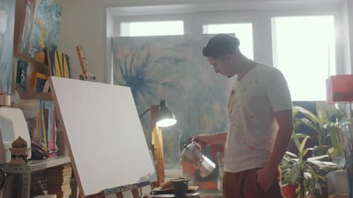 Artist Drinking Coffee and Drawing Picture in Studio