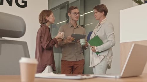 Colleagues Having Coffee Break in Office