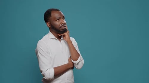 Pensive Young Adult Brainstorming Ideas to Find Solution