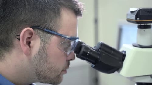 Side View Professional Chemist Wearing Glasses Examining Virus Covid-19 Sample Spbas. Learning