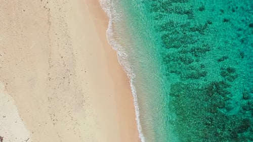 Tropical fly over abstract shot of a white paradise beach and blue water background in vibrant 4K