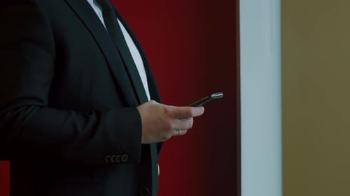 Man in Suit Using Cell Phone in Office