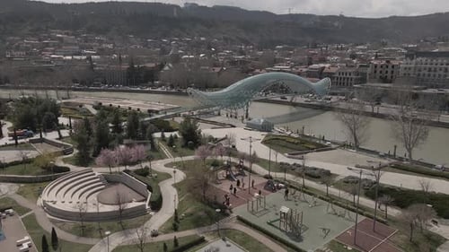 Tbilisi, Georgia - April 2 2021: Aerial view of Tbilisi city central park and Bridge of Peace.