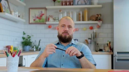 Adult Man Talking at Wooden Table Indoors