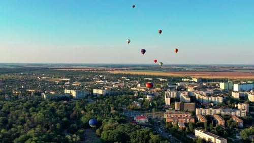 Aerial View of Hot Air Balloons Over City