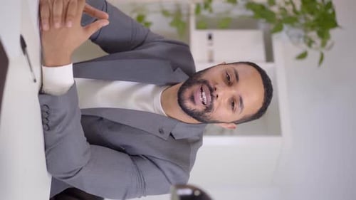 Man Giving Presentation at Desk in Office