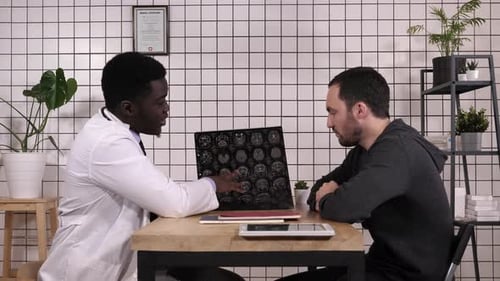 Doctor Explains MRI to Patient in Office