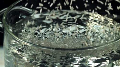 Rice Falls Into a Pot of Boiling Water