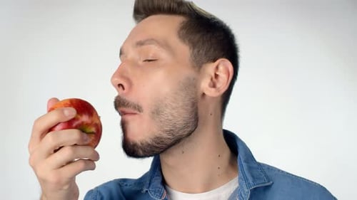Man Eating Juicy Red Apple in Close-Up