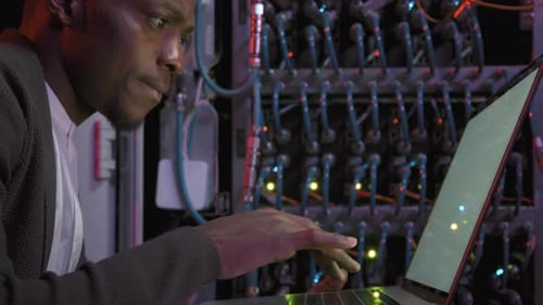 African-American Network Engineer Working in Data Center