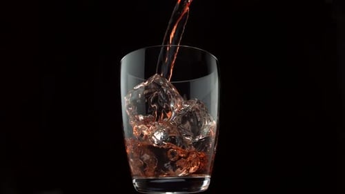 Pouring whiskey into glass, Slow Motion