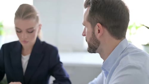 Business Meeting With Three Adults in Bright Office