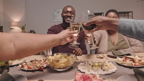 Friends and Family Toasting with Wine Indoors