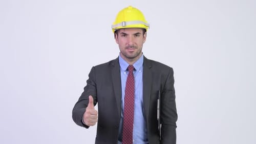 Young Happy Hispanic Businessman As Engineer Giving Thumbs Up