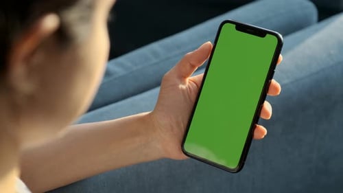 Handheld Camera: Back View of Brunette Woman Holding Chroma Key Green Screen Smartphone