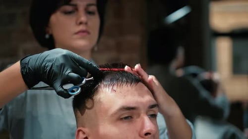 Barber Cuts the Hair of the Client with Scissors Close-up. Frame. Barber Combing Hair and Cutting