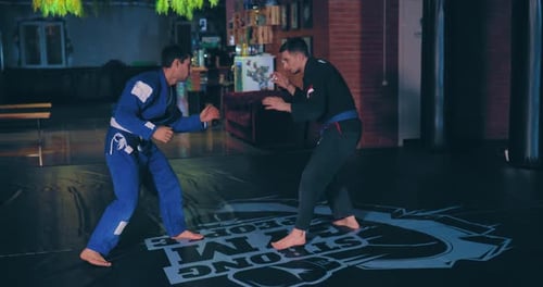 Intense Grappling Match Between Two Adult Male Athletes