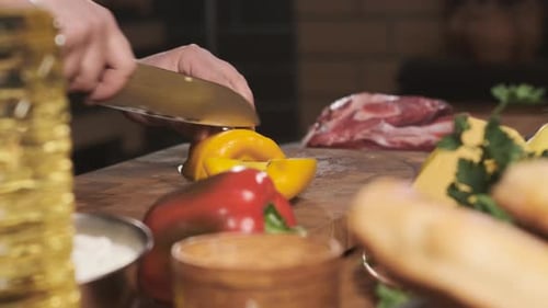 Extreme Close Up Chef in Restaurant Kitchen Cut Yellow Pepper with Sharp Shiny Knife