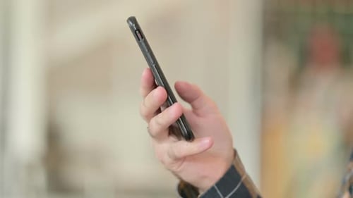 Close Up of Hand Using Smartphone