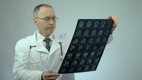 Doctor Examines Brain X-Ray Scan in Hospital