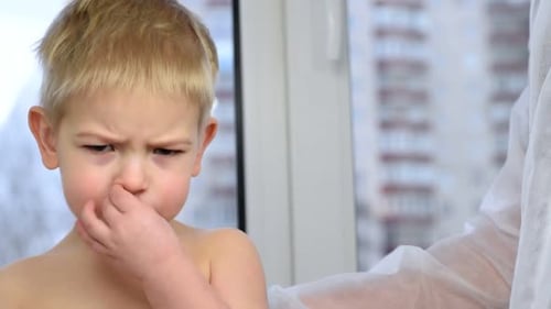 Child Receives Vaccination from Doctor at Clinic