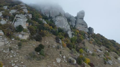 Mountains with Rocky Sculptures That are Getting Covered By Clouds