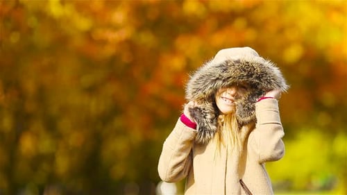 Porträt eines entzückenden kleinen Mädchens im Freien an einem schönen warmen Tag mit gelbem Blatt im Herbst